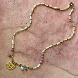 Handmade hand knotted mother of pearl asymmetrical necklace.